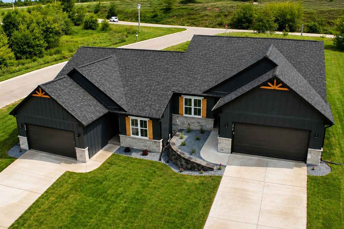 Oak & Origin custom built home, Wisconsin Aerial view of a modern dark-sided custom home with stone accents.